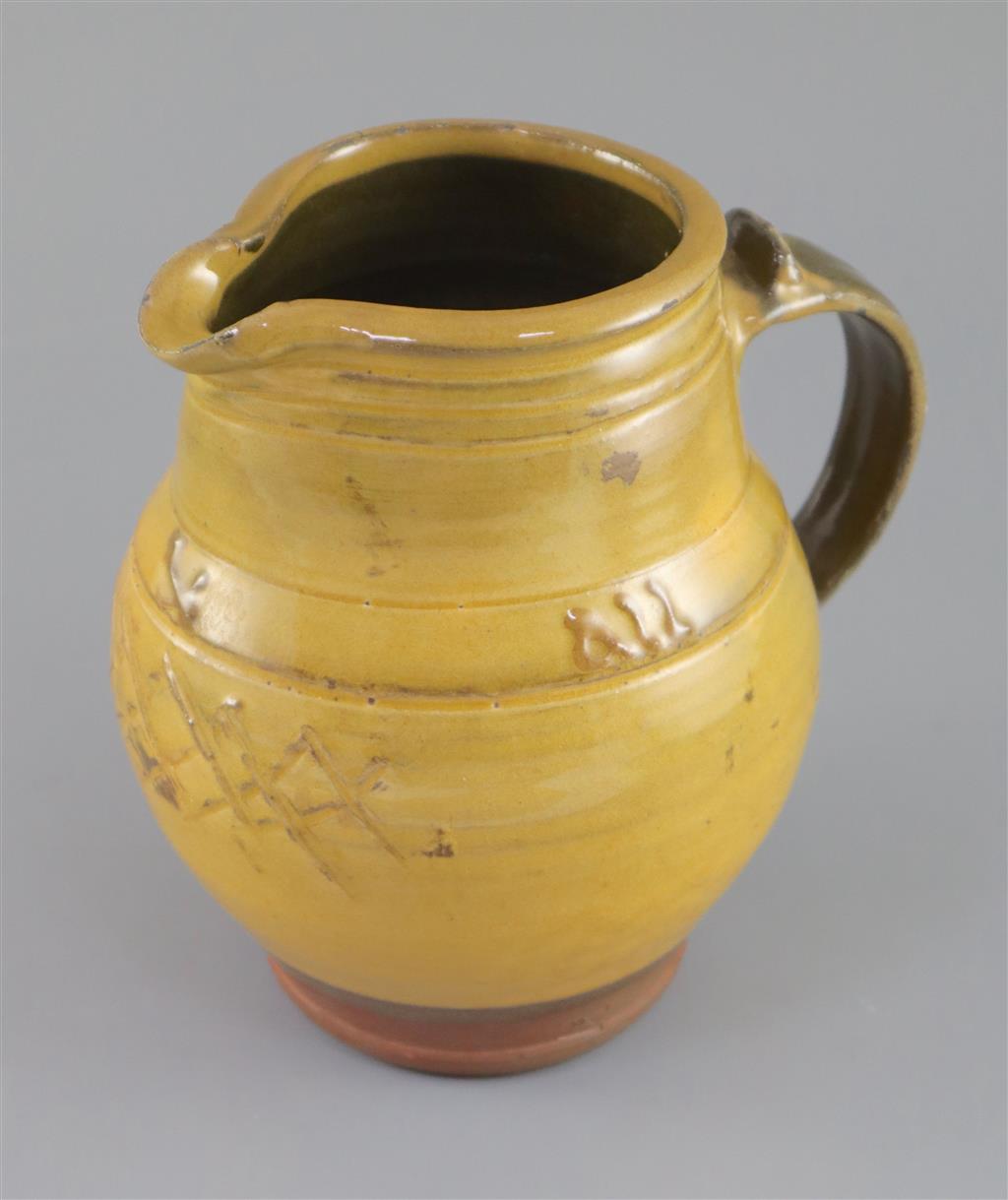 Bernard Howell Leach (1887-1979). A mustard-glazed slipware jug, 17cm high